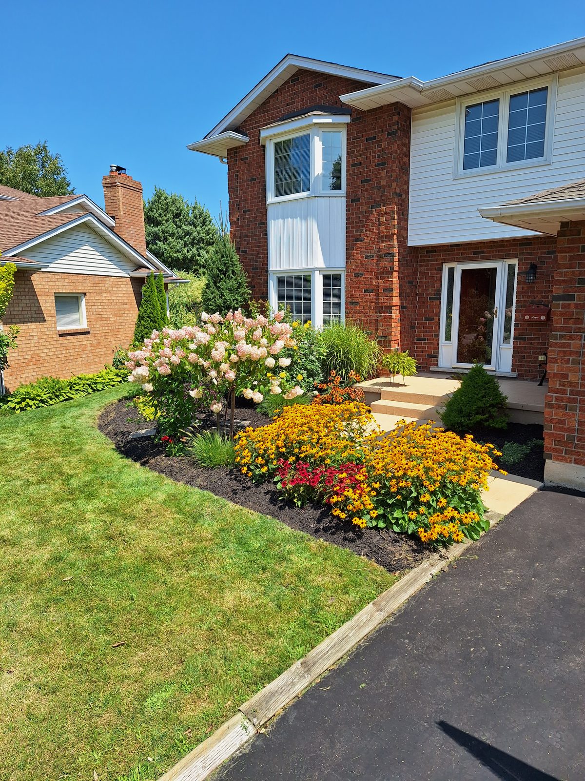 Colourful flower garden bed maintained by Steadfast Home Services